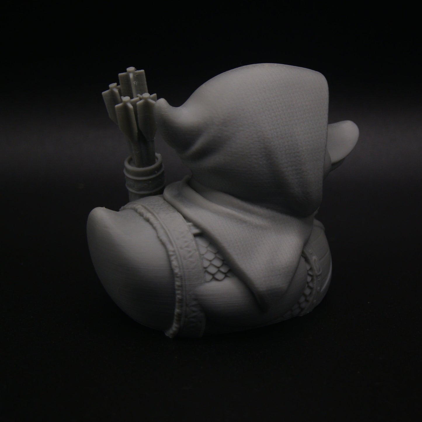 Gray 3D model of a character with a hat on a black background