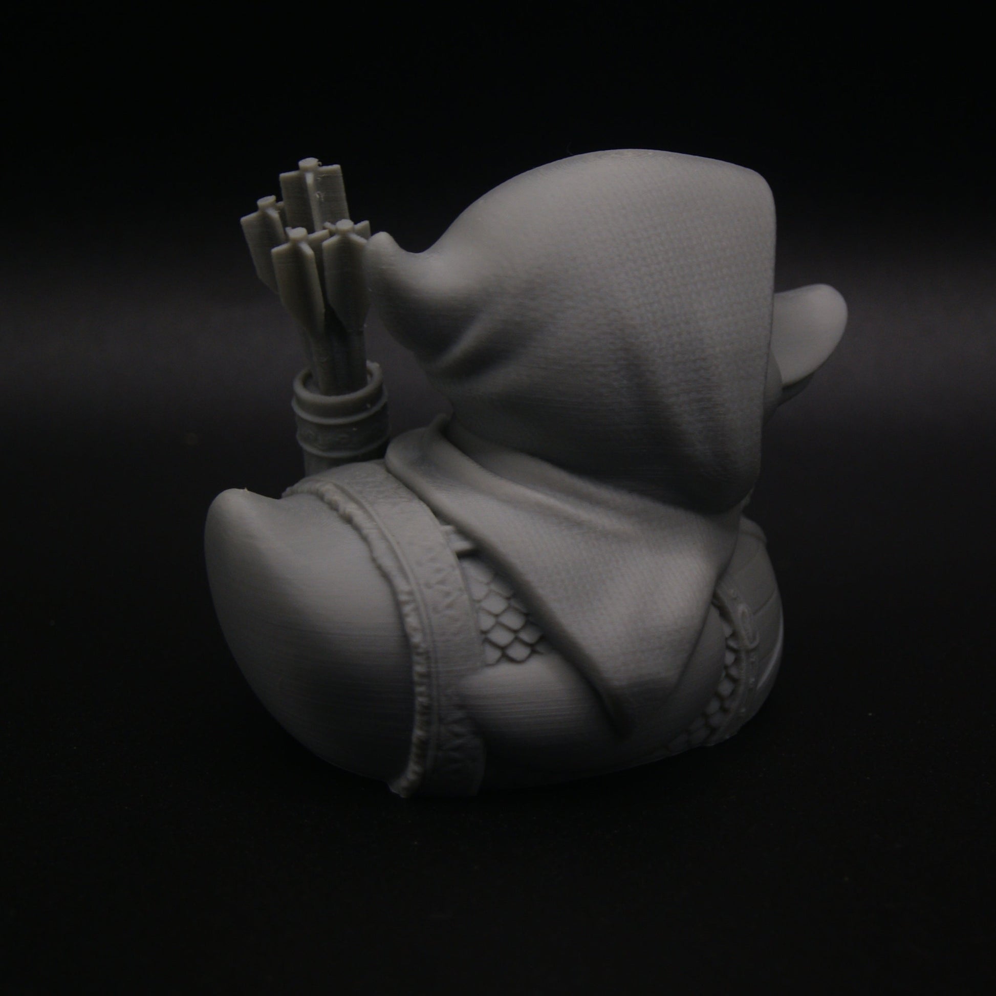 Gray 3D model of a character with a hat on a black background